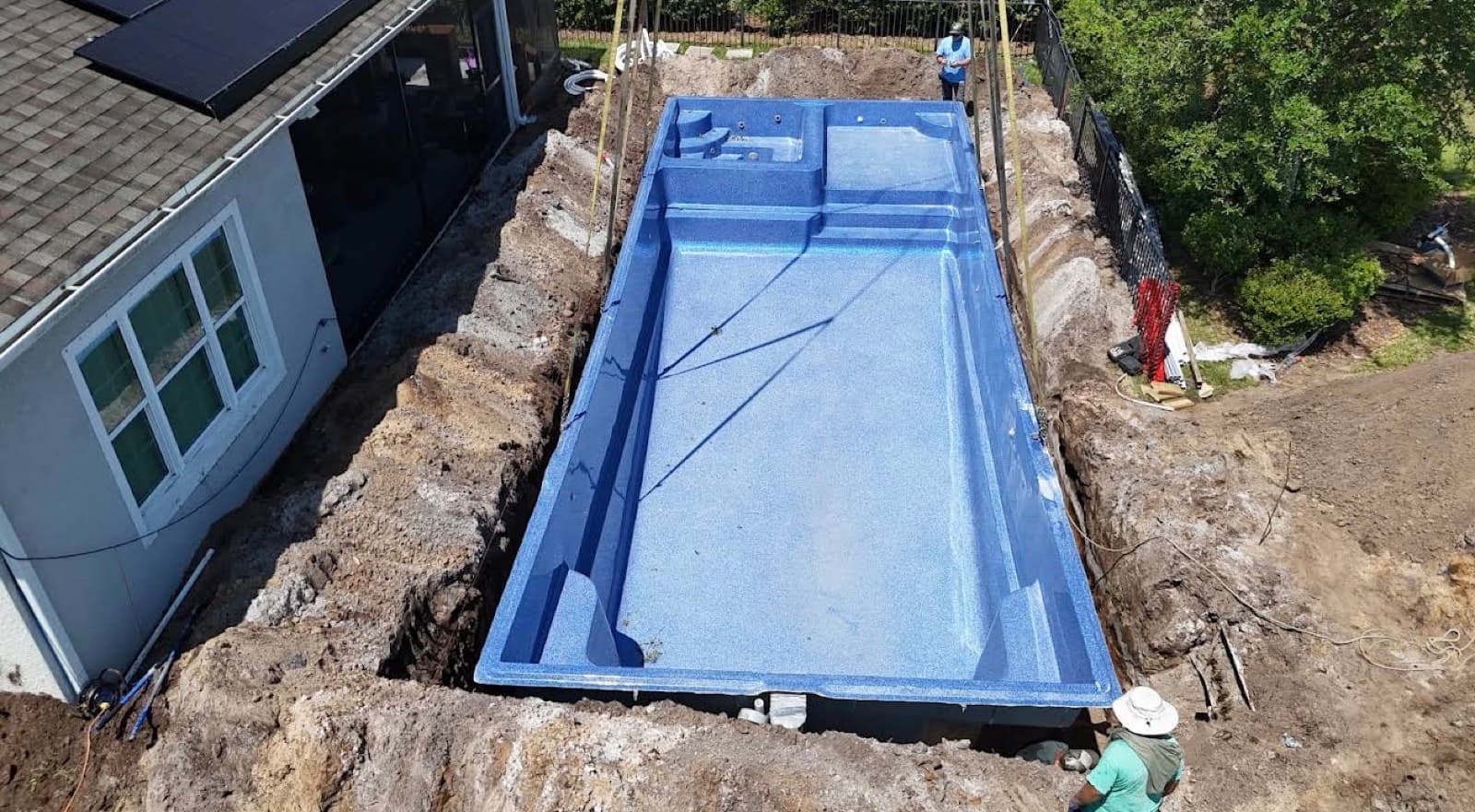 Aerial view of a fiberglass pool shell set during a Terra Core Excavation install